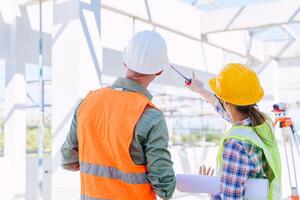 Engineer builder architect team working check roof beam construction progress structure building. photo