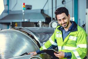 Happy engineer male worker working in factory work check boiler water pipe in factory, portrait smile. photo