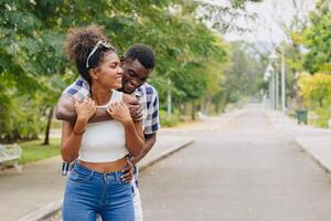 Date couple man and women valentine day. African black lover at park outdoors summer season vintage color tone photo