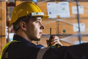 Caucasian Russian male engineer staff worker team control loading cargo shipping in warehouse storage management photo