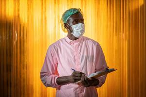 Black African worker in food and drink hygiene staff officer walking check products quality around factory. photo