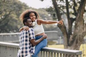 Date couple man and women valentine day. African black lover at park outdoors summer season vintage color tone photo