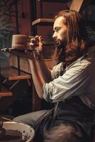 Pottery worker. handcraft making artisan male pot maker with hand made clay cup photo