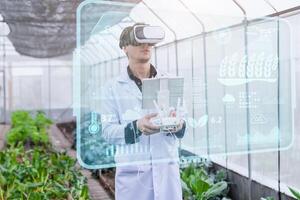 agriculture scientist using modern plant growing research technology device VR system to monitor plant grow information system photo