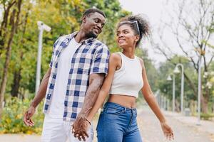 Date couple man and women valentine day. African black lover at park outdoors summer season vintage color tone photo