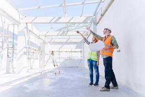 Engineer builder architect team working check  progress construction of the roof structure of the building. photo