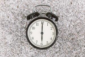 Closeup Retro Bell Clock on show time 6 o'clock focus on center object for remind alert concept photo