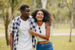 Date couple man and women valentine day. African black lover at park outdoors summer season vintage color tone photo