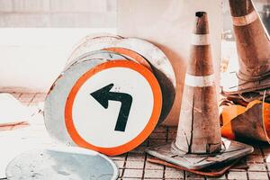 old unused dirty broken road traffic sign banner and traffic cone waste grunge photo