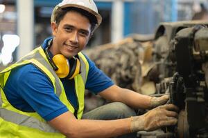 portrait young male worker engineer working in heavy industry with safety happy smile looking camera photo