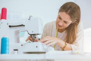 costume professional woman work enjoy with digital sewing machine happy in tailor studio photo