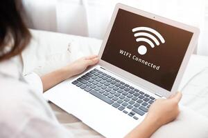 People using laptop connect to Internet using WIFI access point home network system photo