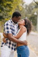 Date couple man and women valentine day. African black lover at park outdoors summer season vintage color tone photo