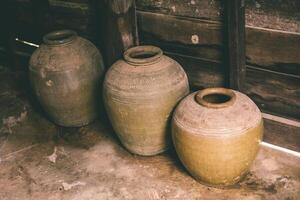 Thai local vintage Vessel Jar northeast style made of baked clay for containing food pickled fish or liqueur photo