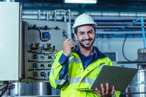 Portrait electricity worker hispanic engineer working in factory checking high voltage electrical power cabinet in factory. photo