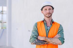 portrait smart confident arm crossed engineer construction worker builder home renovate service man photo
