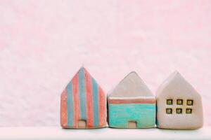 cute small house toy with pink copy space for text for postcard home and community background photo