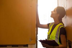 Warehouse staff worker reading cargo label. People working for inventory goods cargo shipping management team. photo