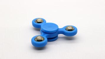 Blue fidget spinner isolated photo