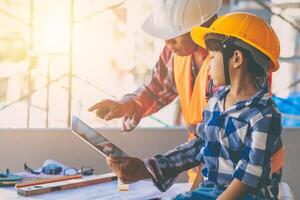 engineer builder family father day role play teaching son kid at construction site photo