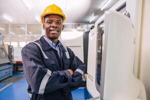 portrait smart black african male engineer worker working with cnc lathe machine in modern metal factory photo