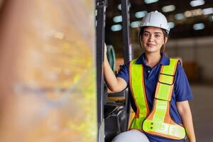Indian woman staff worker engineer supervisor in safety suit work in factory warehouse photo