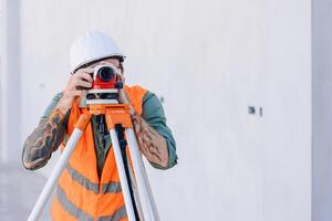 Engineer builder working with Auto Level camera look aim levelling survey construction building floor photo