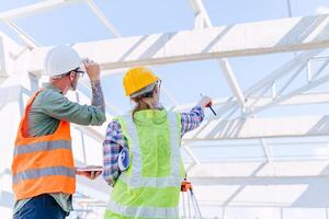 Engineer builder architect team working check roof beam construction progress structure building. photo