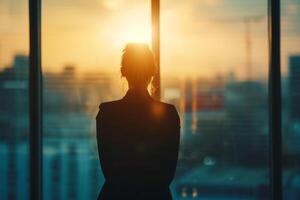 AI generated Back view of a a young businesswoman looks at a cityscape from an office window. Generative AI photo