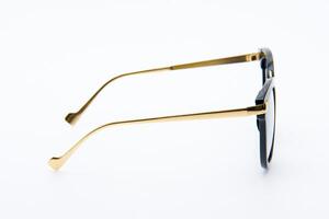 Fashion sunglasses black and gold frames on the white background. photo