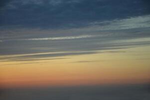 Beautiful natural sunrise, sunset against a dark blue sky with an orange stripe. Abstract background. photo