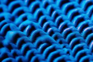 AI generated Texture of knitted fabric of a blue sweater with large loops. Beautiful textured background. photo