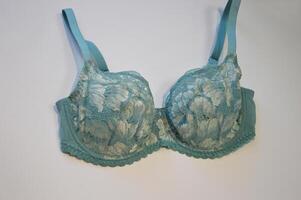 Lingerie. Light blue lace bra on a white background. Stylish women's underwear. photo