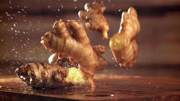 Fresh ginger falls on the table. Filmed on a high-speed camera at 1000 fps. High quality FullHD footage video