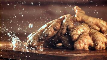Drops of water fall on fresh ginger. Filmed on a high-speed camera at 1000 fps. High quality FullHD footage video