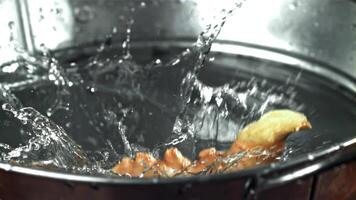 Fresh ginger falls into the water. Filmed on a high-speed camera at 1000 fps. High quality FullHD footage video