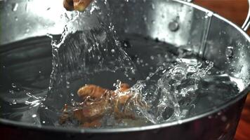 Fresh ginger falls into the water. Filmed on a high-speed camera at 1000 fps. High quality FullHD footage video