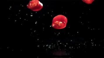 Sliced chunks of chili pepper falling on a black background. Filmed on a high-speed camera at 1000 fps. High quality FullHD footage video