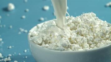 Milk is poured into fresh cottage cheese. Filmed on a high-speed camera at 1000 fps. High quality FullHD footage video