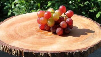 A lot of ripe purple grapes on wooden background photo