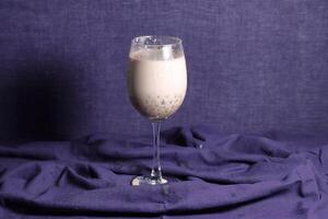 Bubble Milk Tea, Brown sugar pearl milk tea on dark background. Taiwan bubble milk tea in glass cup with coffee latte flavor on texture background, summers refreshment photo