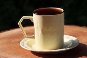 Hot tea on wooden in the evening.  Healthy hot drink. Black tea drink photo