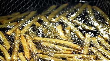 French fries are deep-fried in oil. Filmed on a high-speed camera at 1000 fps. High quality FullHD footage video