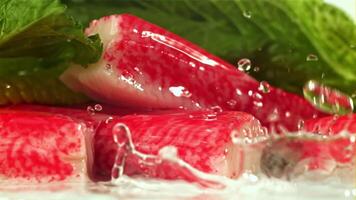 Drops of water fall on fresh crab sticks. Filmed on a high-speed camera at 1000 fps. High quality FullHD footage video