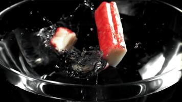 Crab sticks fall into the water. Filmed on a high-speed camera at 1000 fps. High quality FullHD footage video