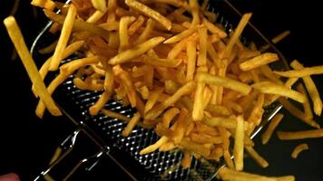 French fries in a deep-frying net in the chef's hand. Filmed on a high-speed camera at 1000 fps. High quality FullHD footage video