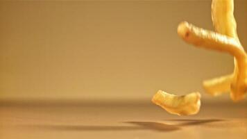 French fries with salt fall on the table. Filmed on a high-speed camera at 1000 fps. High quality FullHD footage video