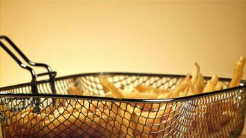 French fries in a deep-frying net in the chef's hand. Filmed on a high-speed camera at 1000 fps. High quality FullHD footage video