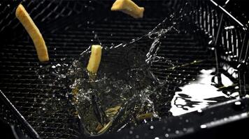 The fries fall into the hot oil. Filmed on a high-speed camera at 1000 fps. High quality FullHD footage video