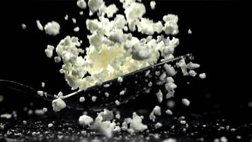 A spoonful of fresh cottage cheese falls on the table. Filmed on a high-speed camera at 1000 fps. High quality FullHD footage video